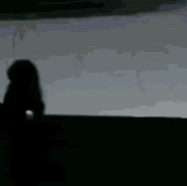 a blurry picture of a group of people standing in a dark room