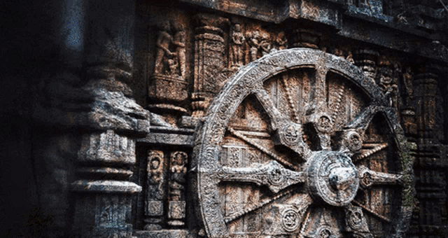 a stone wheel with a circular design on it is on a wall