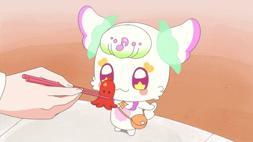 a person is feeding a cartoon character a piece of food