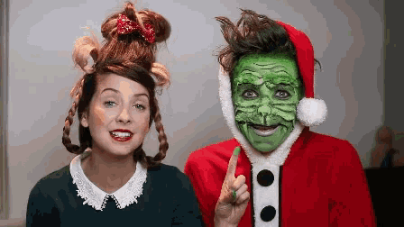 a man and a woman are dressed as the grinch