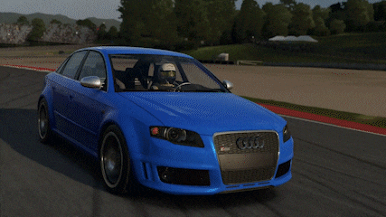 a blue audi car is driving down a track