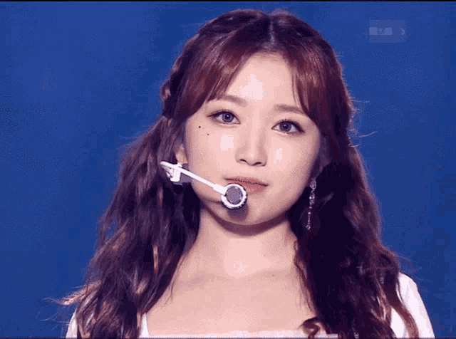 a close up of a woman 's face with a microphone on her face