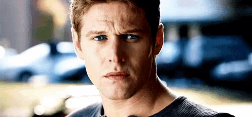 a close up of a man 's face with a serious expression .