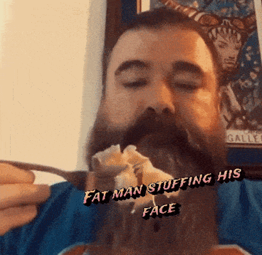 a man with a beard is holding a fork and says fat man stuffing his face