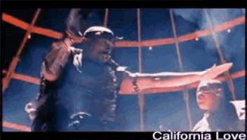 a man singing into a microphone with the words california love written below him