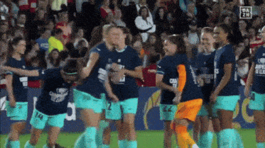 a group of female soccer players wearing shirts that say champions