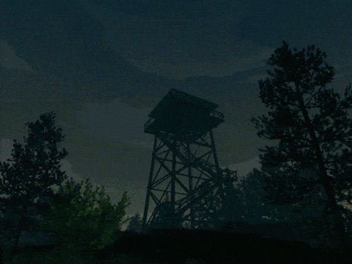 a tower in the middle of a field with a blue sky in the background