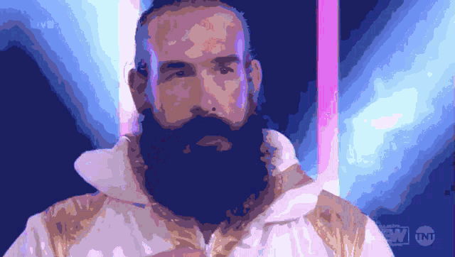 a man with a beard is wearing a white and gold jacket with tnt written on the bottom