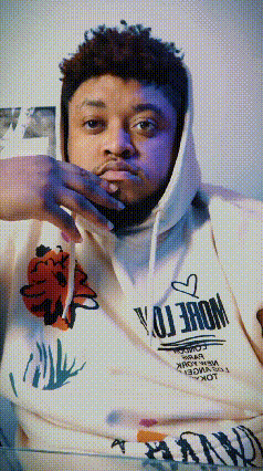 a man wearing a white hoodie that says " more " on it