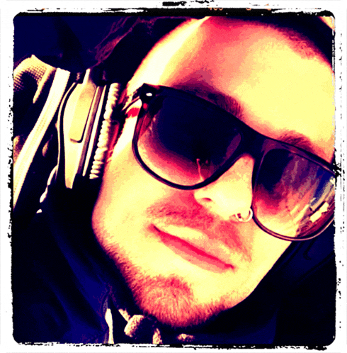 a man wearing sunglasses and headphones has a piercing in his nose