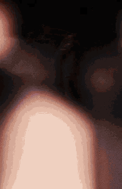 a blurry picture of a person 's back in the dark