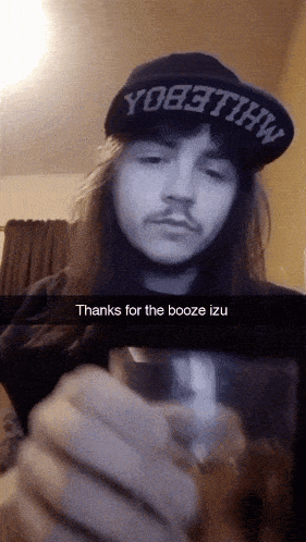 a man with long hair wearing a hat that says yo8tthw on it
