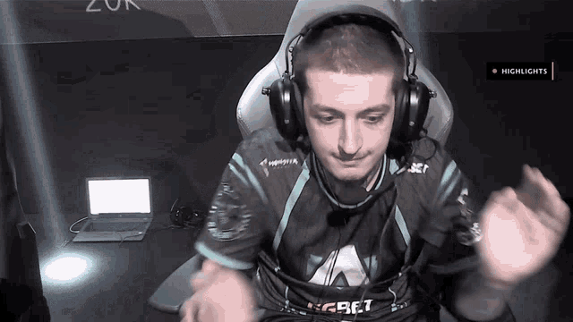 a man wearing headphones and a shirt that says craft is sitting in front of a laptop