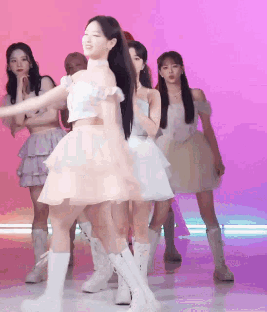 a group of young women are dancing together on a stage