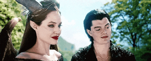 a man and a woman are standing next to each other .