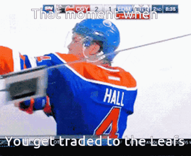 a hockey player wearing a blue jersey with the number 4 on it