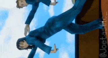 a man in a blue suit is doing a trick on another man