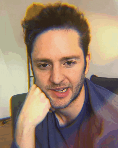a man with his hand on his chin is smiling