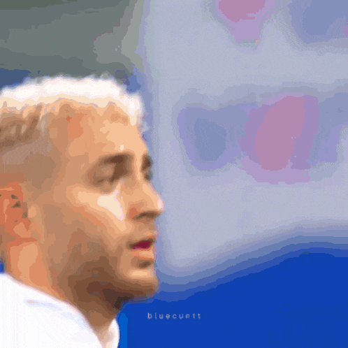 a blurry picture of a man 's face with the words bluecuntt on the bottom right