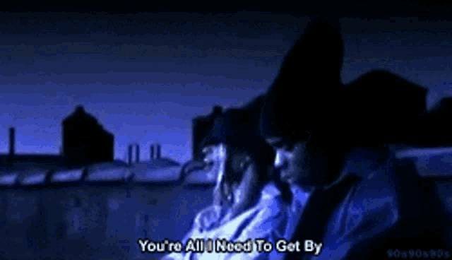 a man says " you 're all i need to get by " in a video