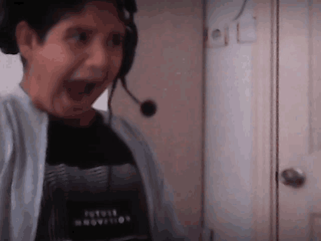 a boy wearing headphones and a shirt that says futuristic