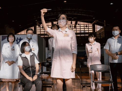 a group of people wearing masks including a nurse with a name tag that says ' a '
