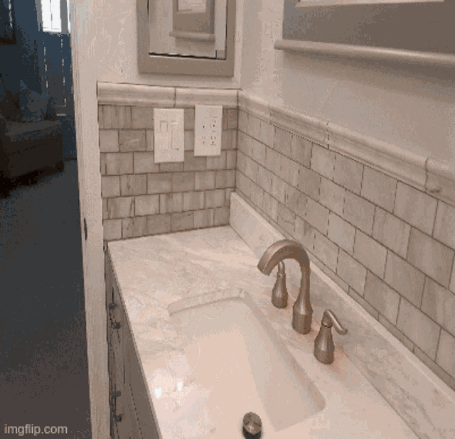 a bathroom with a sink and a mirror with the url imgflip.com
