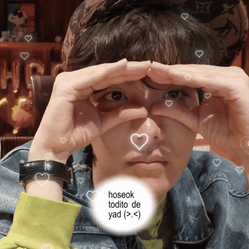 a person making a heart shape with their hands and the words hoseok todo de yad
