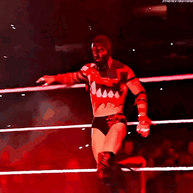 a man in a wrestling ring with the next thing written on the bottom right