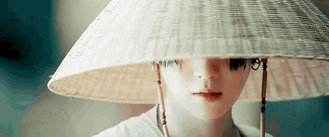 a close up of a person wearing a conical hat .