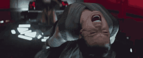 a woman is laying on her back with her mouth open and her eyes closed .