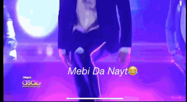 a man in a suit is dancing with the words mebi da nayt on the screen