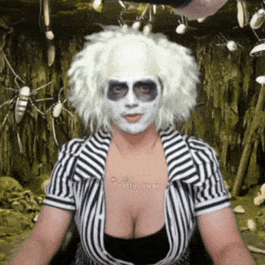 a woman wearing a striped shirt and a white wig has toastypawgz on her chest