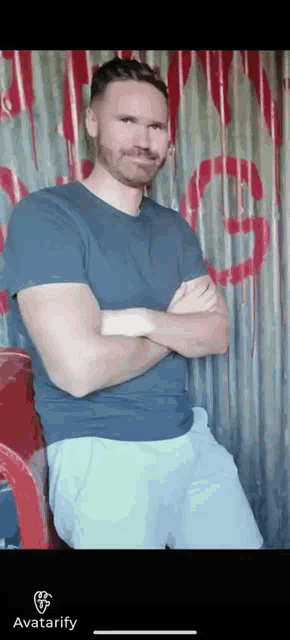 a man with his arms crossed is standing in front of a wall that has the word avatarify on it
