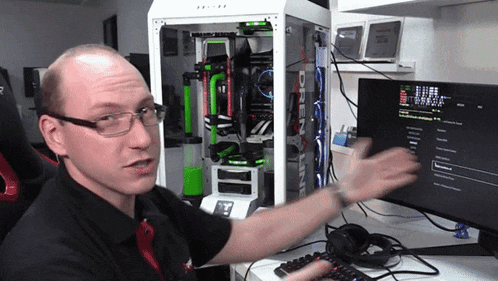 a man sitting in front of a computer with a screen that says ' drainline ' on it