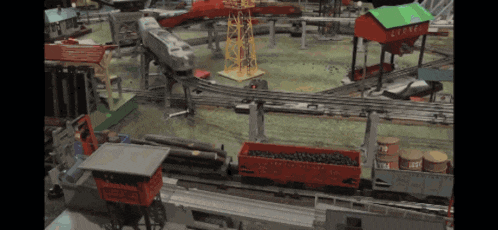 a toy train set with a red container that says ' lionel ' on the side
