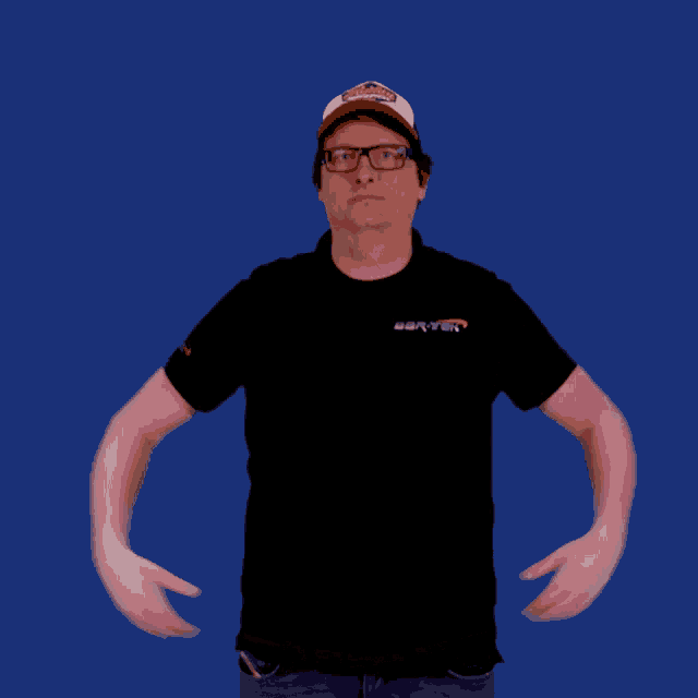 a man flexing his muscles wearing a black shirt and a hat that says champions on it