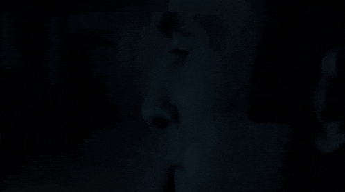 a close up of a person 's face in the dark with the words `` it 's '' written in white .