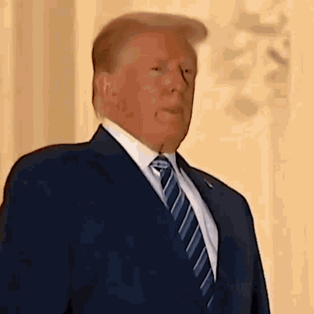 a close up of a man in a suit and tie .