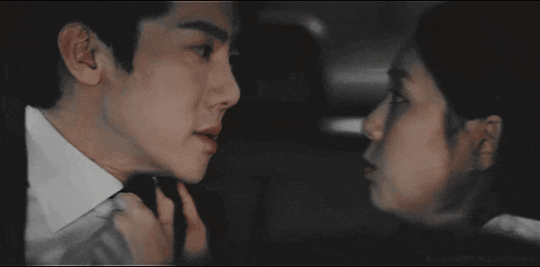 a man and a woman are looking at each other .