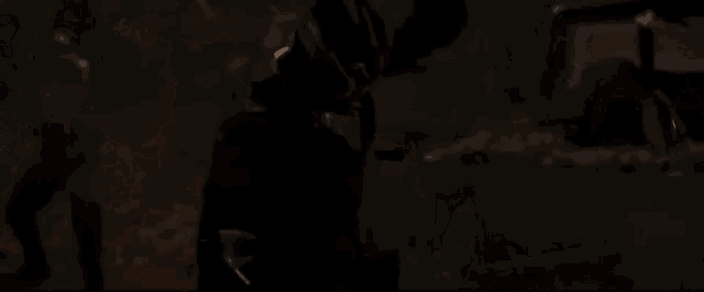 a close up of a person 's face in a dark room with fire coming out of it .