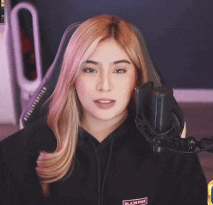 a woman wearing a black hoodie with the word blackpink on the front
