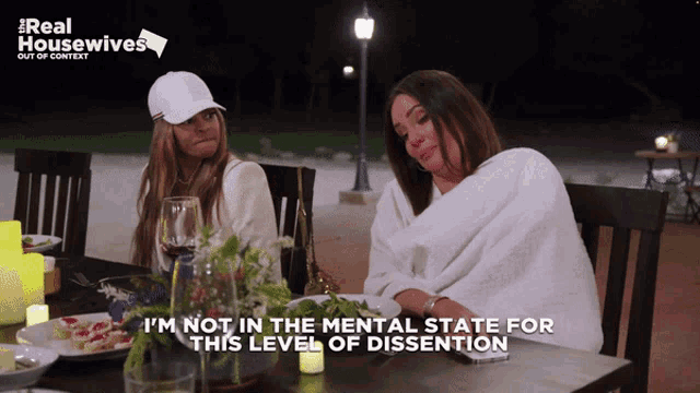 two women sitting at a table with the words i 'm not in the mental state for this level of dissention on the bottom