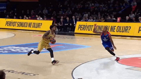 a basketball game is being played in front of a sign that says periyot