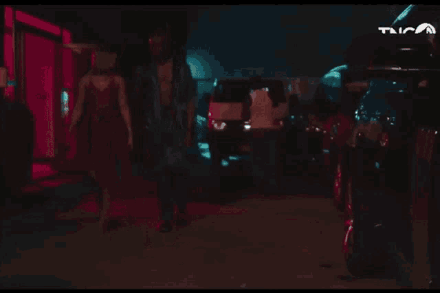 a man and a woman dancing in a dark room