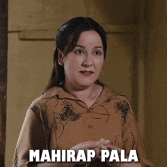 a woman in a brown shirt with mahirap pala written on her chest