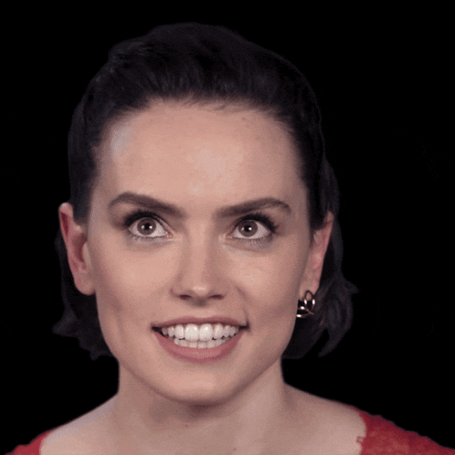 a close up of a woman 's face with earrings on