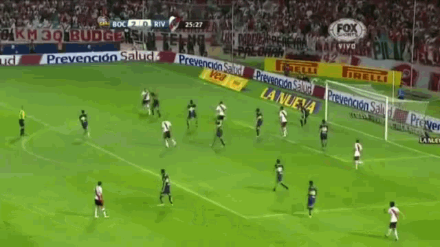 a soccer game is being played on a field with a fox logo in the background