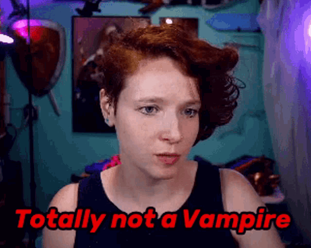 a woman with red hair and the words totally not a vampire