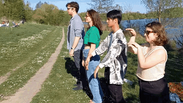 a group of people standing next to each other on a path